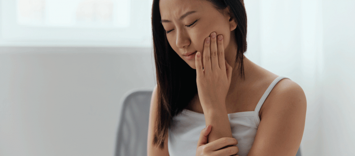 young women unhappy suffering from hurting tooth